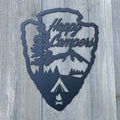 Happy Campers Arrowhead Metal Sign Cutout - A Powder Coated Metal Sign Featuring a Tent Camping Scene in the Shape of an Arrow Head