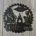 Bigfoot and Alien Campfire Metal Sign - UFO and Wilderness Wall Art - Welcome Sign - Gift for Conspiracy Theorist - Humorous Decor