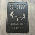 Slow Squatches at Play Metal Sign - Bigfoots on Teeter Totter Design