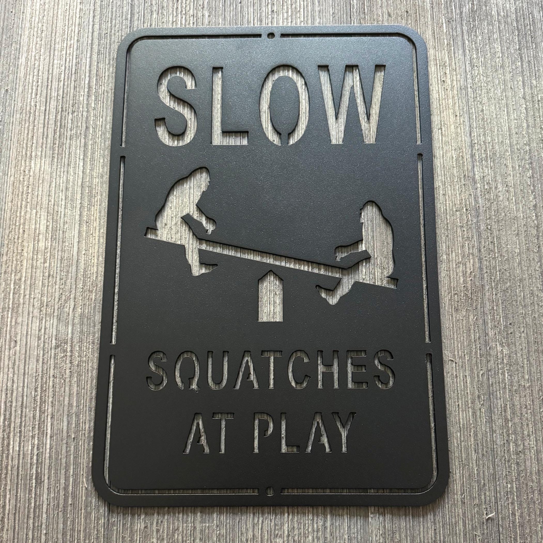 Slow Squatches at Play Metal Sign - Bigfoots on Teeter Totter Design